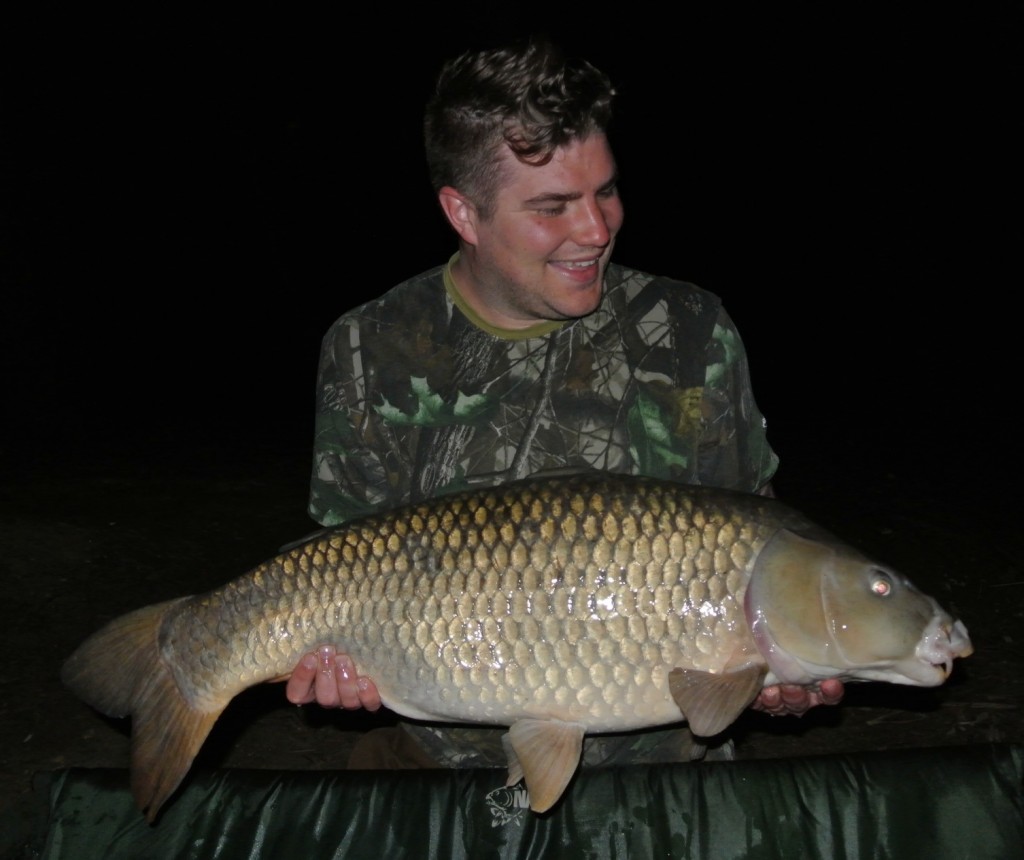 Adam Newcombe with a personal best 30lb 12oz Common from Heron lake