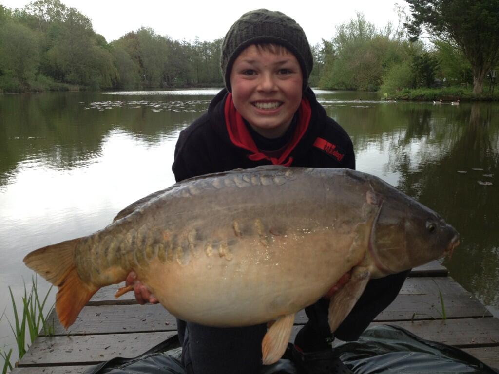 Young Harry Soames with a 31lb 4oz PB Mirror from Heron. 'Beat that Dad!'