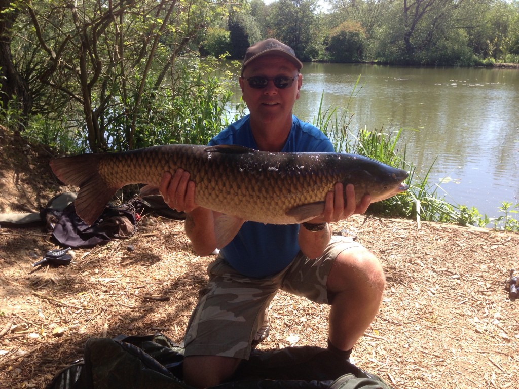 Eric Stamford with a 20lb 6 oz grass carp from Heron